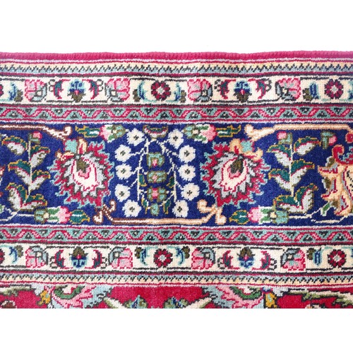 1521 - Carpet / Rug: A North West Persian Tabriz carpet the red ground with central cream and blue medallio... 