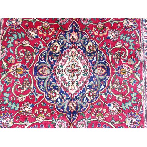 1521 - Carpet / Rug: A North West Persian Tabriz carpet the red ground with central cream and blue medallio... 