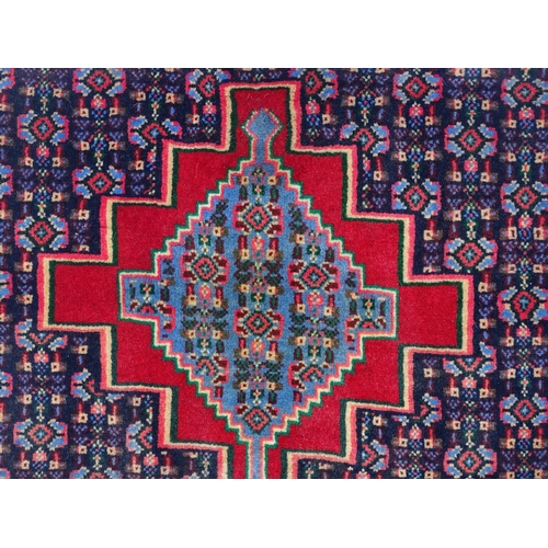 1514 - Carpet / Rug: A North West Persian Senneh runner the navy ground decorated with repeating geometric ... 