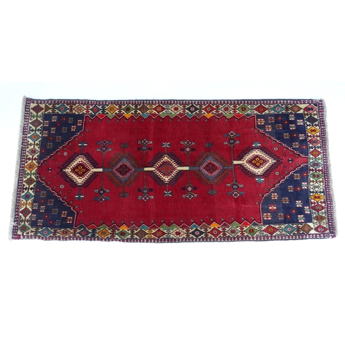 1516 - Carpet / Rug: A South West Persian Qashqai rug the red ground decorated with geometric motifs. Appro... 