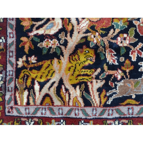 1522 - Carpet / Rug : A blue and cream ground rug decorated with elaborate tree decoration with various bir... 
