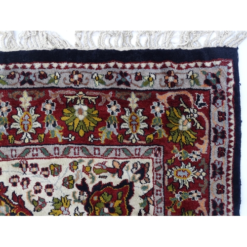 1522 - Carpet / Rug : A blue and cream ground rug decorated with elaborate tree decoration with various bir... 