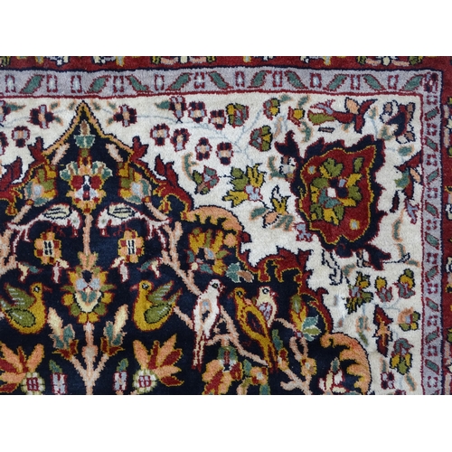 1522 - Carpet / Rug : A blue and cream ground rug decorated with elaborate tree decoration with various bir... 