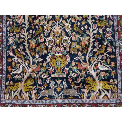 1522 - Carpet / Rug : A blue and cream ground rug decorated with elaborate tree decoration with various bir... 