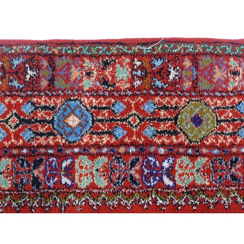 1504 - Carpet / Rug : A Moroccan red ground rug with central floral motif, decorated with birds and foliate... 