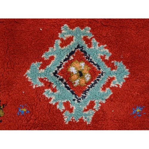 1504 - Carpet / Rug : A Moroccan red ground rug with central floral motif, decorated with birds and foliate... 