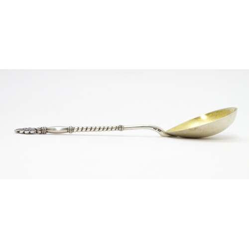 272 - A Russian silver spoon with gilded bowl and twist decoration to handle. Approx 7 1/2