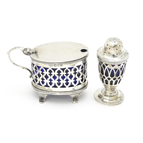 456 - A pair of white metal salts with griffin detail and clear glass liners. Together with a silver peppe... 