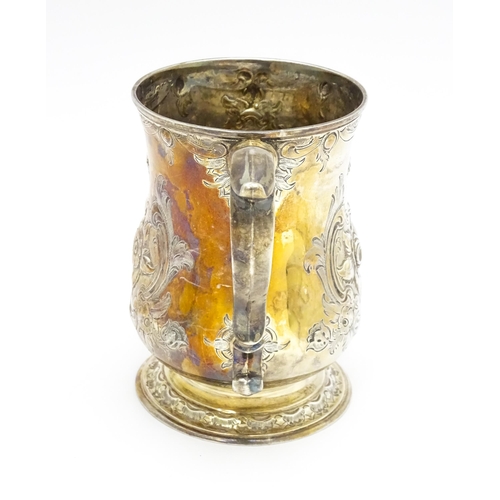 457 - A Victorian silver tankard with embossed floral decoration hallmarked Sheffield 1881, maker Martin, ... 