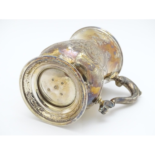 457 - A Victorian silver tankard with embossed floral decoration hallmarked Sheffield 1881, maker Martin, ... 