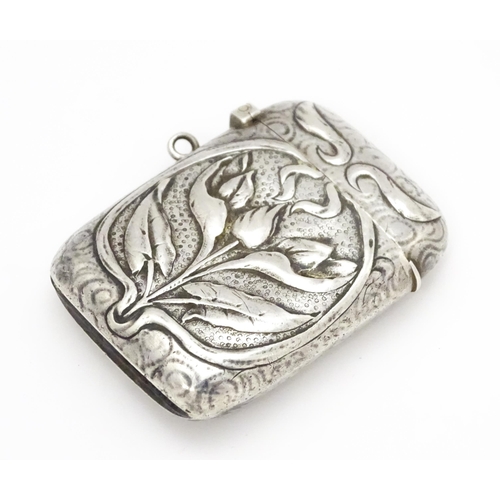 458 - An Art Nouveau white metal vesta case with embossed floral detail. Approx. 2