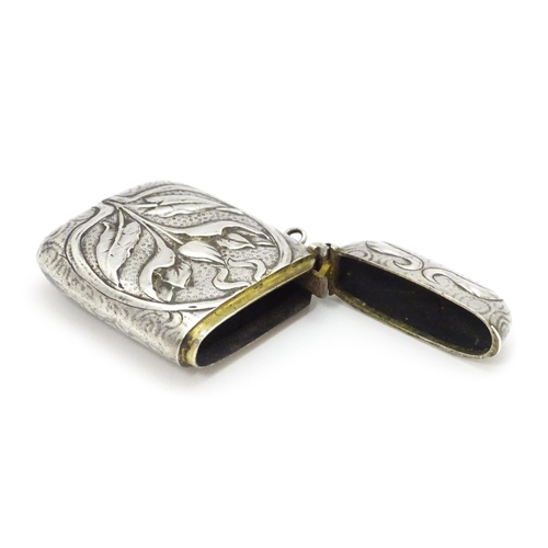 458 - An Art Nouveau white metal vesta case with embossed floral detail. Approx. 2