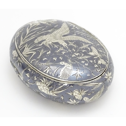 467 - A Continental white metal snuff box of oval form with niello decoration depicting birds, nests, inse... 