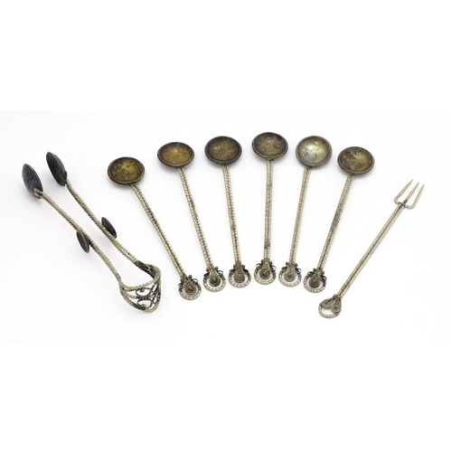 472 - A set of six white metal spoons with tongs en suite with coin formed bowls. Together with an anchovy... 