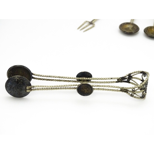 472 - A set of six white metal spoons with tongs en suite with coin formed bowls. Together with an anchovy... 