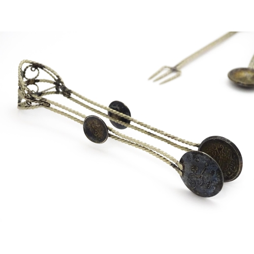 472 - A set of six white metal spoons with tongs en suite with coin formed bowls. Together with an anchovy... 