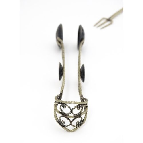 472 - A set of six white metal spoons with tongs en suite with coin formed bowls. Together with an anchovy... 