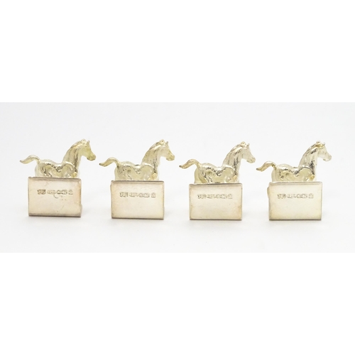 473 - A set of four Elizabeth II hallmarked silver menu / place card holders with horse detail, maker Came... 