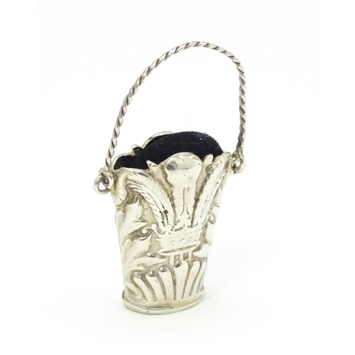 476 - A silver novelty pin cushion formed as a bucket with swing handle. Approx 1 3/4