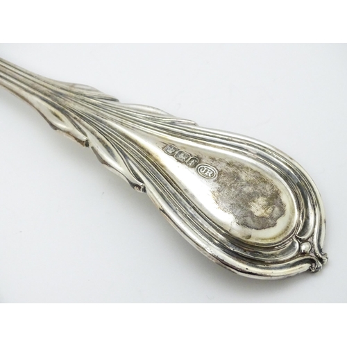 484 - A Victorian silver Lily pattern stuffing / basting spoon. Together with Victorian silver Lily patter... 