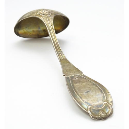 489 - An American sterling silver sauce ladle by Tiffany & Co. the handle decorated with rams head and dev... 