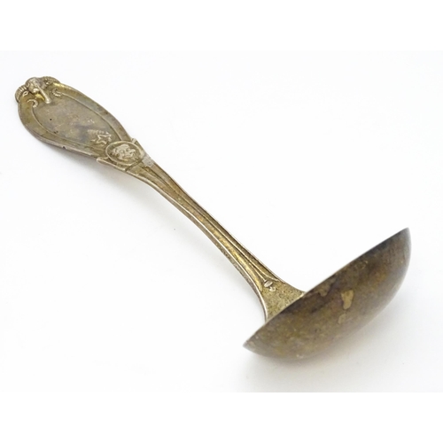 489 - An American sterling silver sauce ladle by Tiffany & Co. the handle decorated with rams head and dev... 