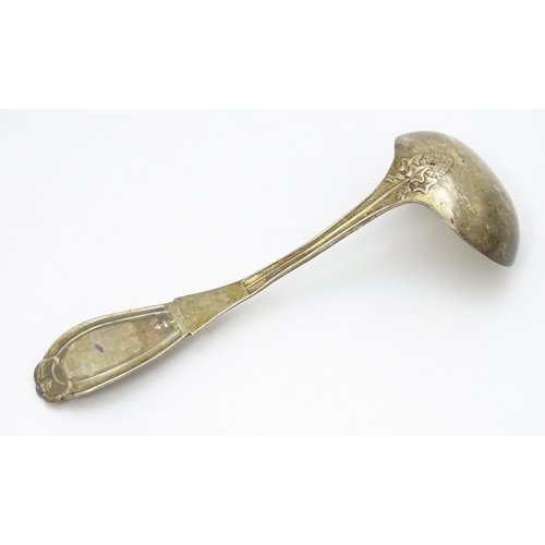 489 - An American sterling silver sauce ladle by Tiffany & Co. the handle decorated with rams head and dev... 