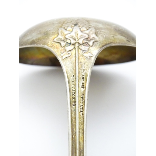 489 - An American sterling silver sauce ladle by Tiffany & Co. the handle decorated with rams head and dev... 