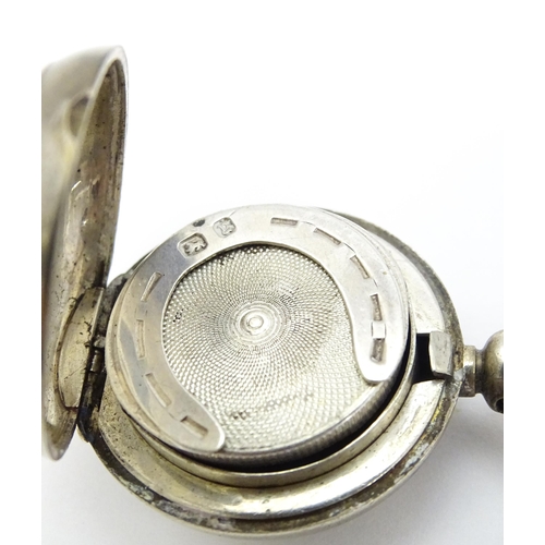 498 - A Victorian silver sovereign case / carrier with engine turned decoration and horseshoe detail withi... 