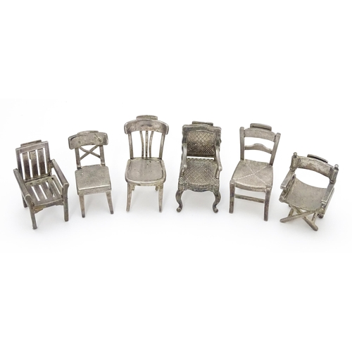 499 - Six assorted silver plate menu / table place card holders each modelled as various types of chairs. ... 