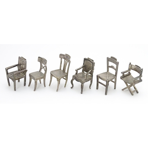 499 - Six assorted silver plate menu / table place card holders each modelled as various types of chairs. ... 