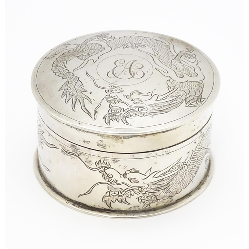 508 - An Oriental white metal pot and cover decorated with dragon detail  in the Chinese Export Silver sty... 