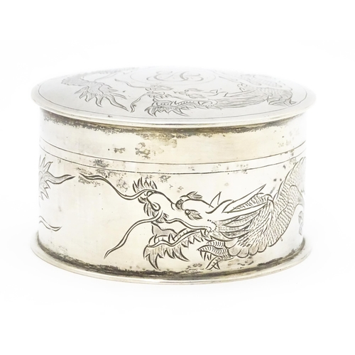 508 - An Oriental white metal pot and cover decorated with dragon detail  in the Chinese Export Silver sty... 