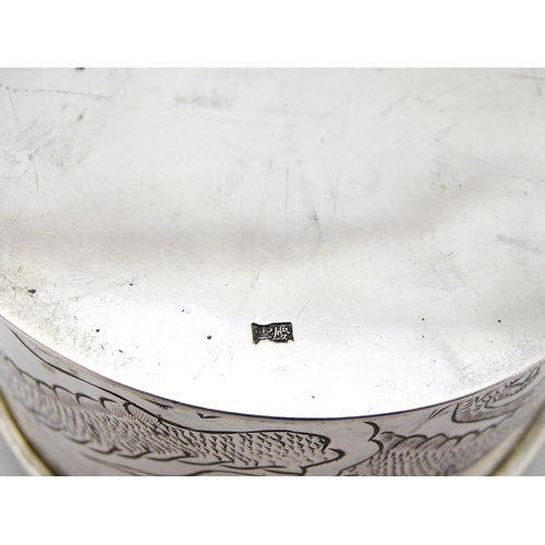 508 - An Oriental white metal pot and cover decorated with dragon detail  in the Chinese Export Silver sty... 