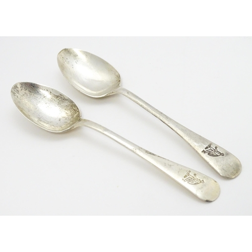 511 - A quantity of assorted silver spoons to include two with engraved decoration depicting a man playing... 