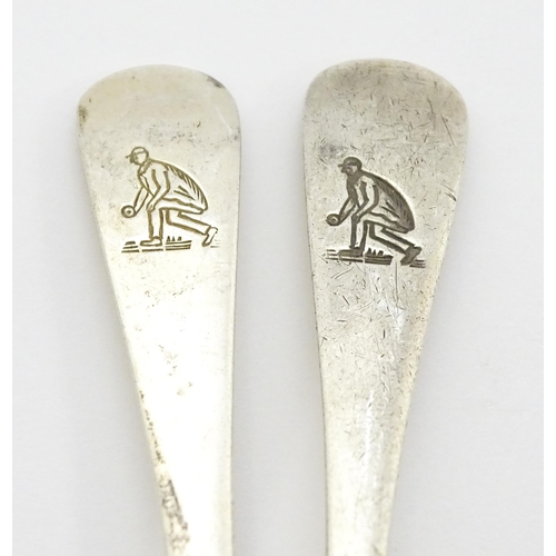 511 - A quantity of assorted silver spoons to include two with engraved decoration depicting a man playing... 