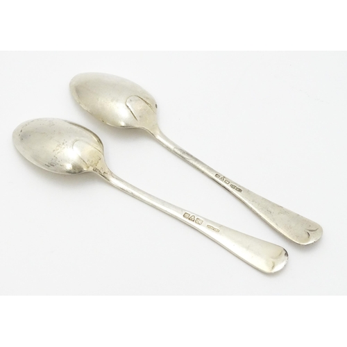 511 - A quantity of assorted silver spoons to include two with engraved decoration depicting a man playing... 