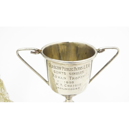 516 - A miniature silver twin handled trophy cup hallmarked Birmingham 1934, maker William Adams Ltd. Toge... 