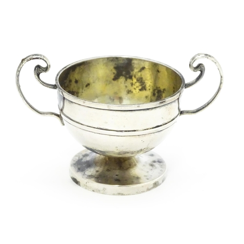 561 - A Chinese export silver twin handled trophy cup of squat form marked under WH 90 for Wang Hing & Co.... 