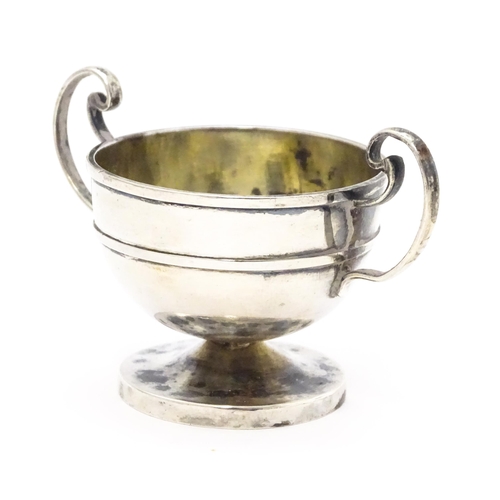 561 - A Chinese export silver twin handled trophy cup of squat form marked under WH 90 for Wang Hing & Co.... 