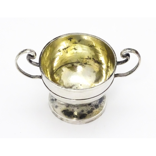 561 - A Chinese export silver twin handled trophy cup of squat form marked under WH 90 for Wang Hing & Co.... 