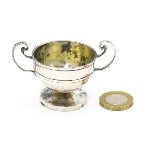 561 - A Chinese export silver twin handled trophy cup of squat form marked under WH 90 for Wang Hing & Co.... 