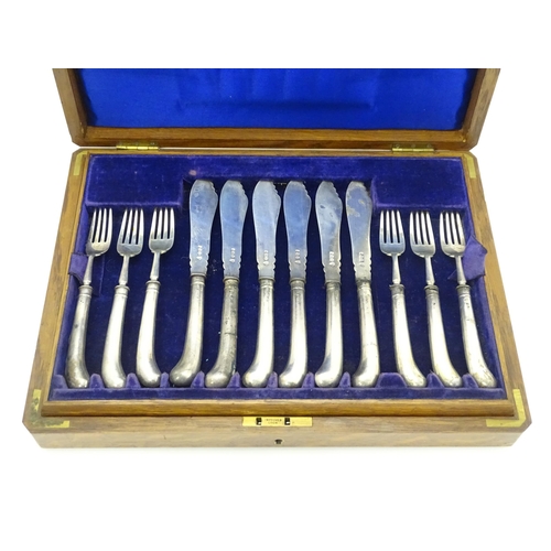 615 - An oak cased set of twelve silver fish knives and forks hallmarked Sheffield 1906, maker J & J Maxfi... 