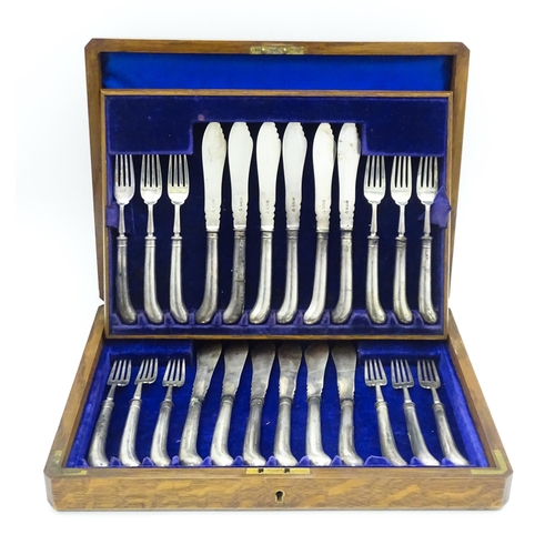 615 - An oak cased set of twelve silver fish knives and forks hallmarked Sheffield 1906, maker J & J Maxfi... 