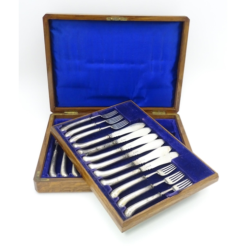 615 - An oak cased set of twelve silver fish knives and forks hallmarked Sheffield 1906, maker J & J Maxfi... 