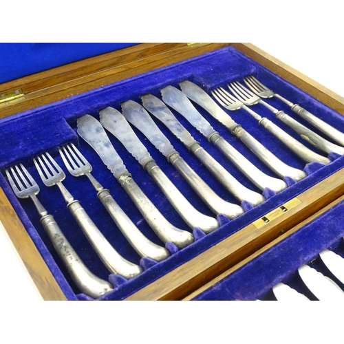 615 - An oak cased set of twelve silver fish knives and forks hallmarked Sheffield 1906, maker J & J Maxfi... 