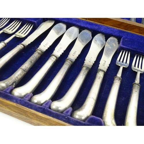 615 - An oak cased set of twelve silver fish knives and forks hallmarked Sheffield 1906, maker J & J Maxfi... 