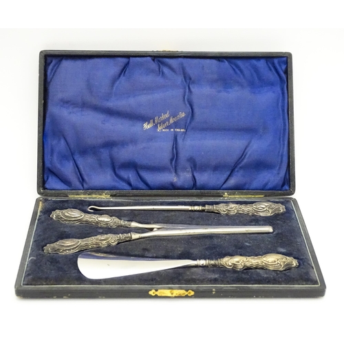 621 - A cased silver handled shoe horn, glove stretchers and button hook hallmarked Birmingham 1907, maker... 