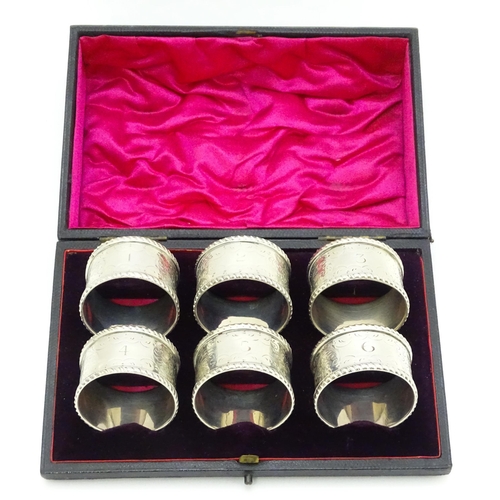 624 - A cased set of six Victorian silver napkin rings with engraved decoration and numbered 1-6, hallmark... 