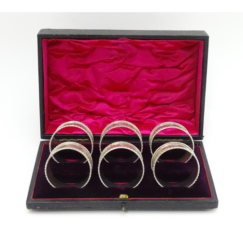 624 - A cased set of six Victorian silver napkin rings with engraved decoration and numbered 1-6, hallmark... 